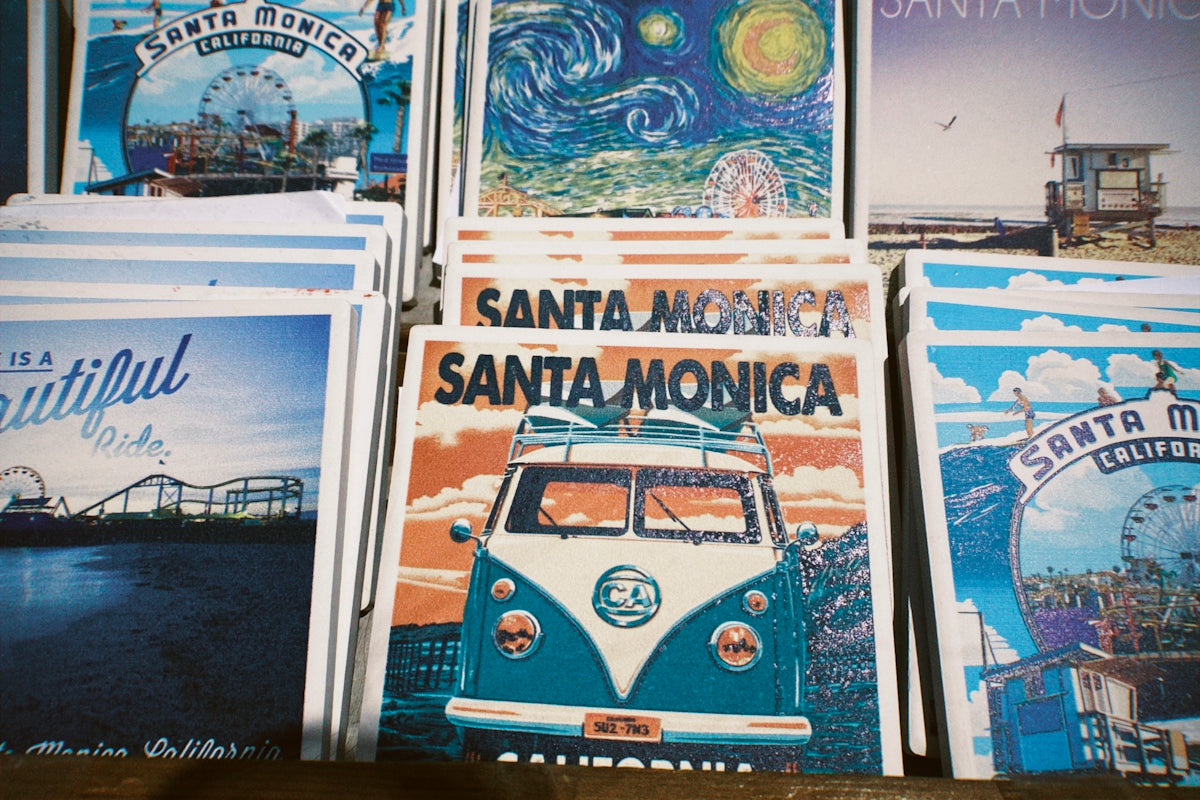 A display of santa monica themed postcards and art prints.